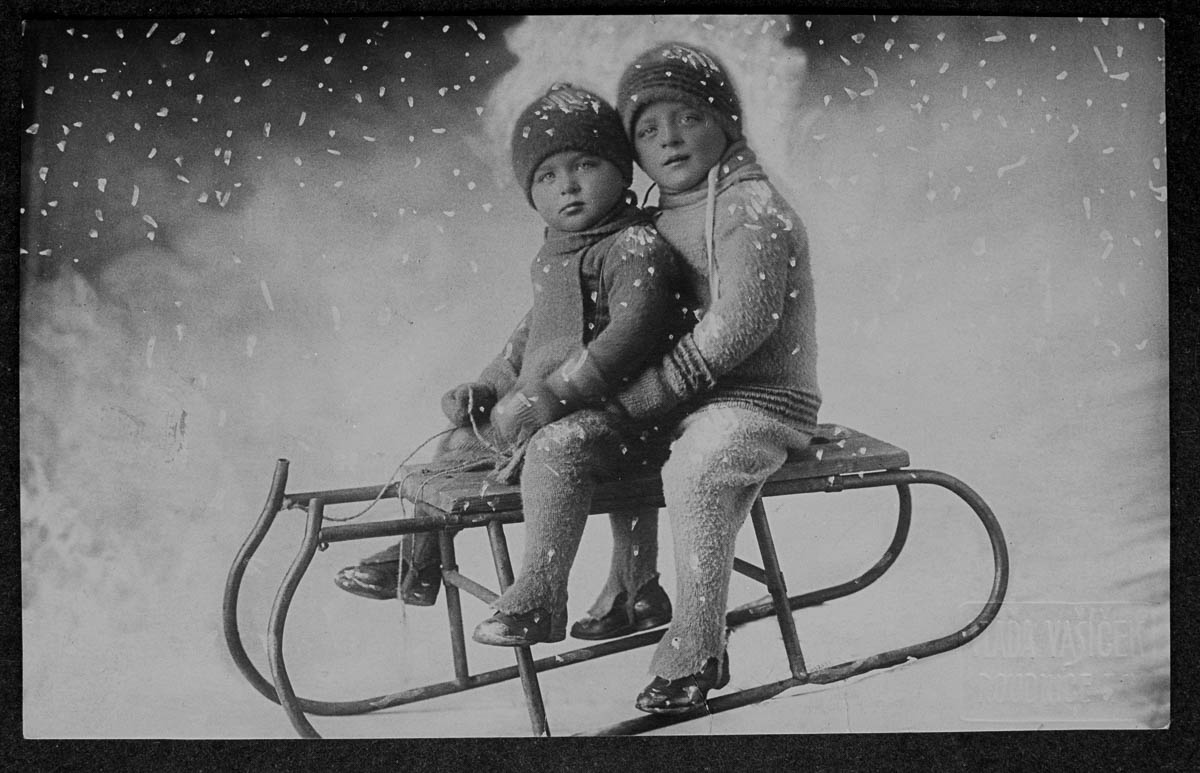 Two young children play on a sled. | Location: Roudnice, Czech Lands. (Photo by V. Vasicek/Scheufler Collection/Corbis/VCG via Getty Images)