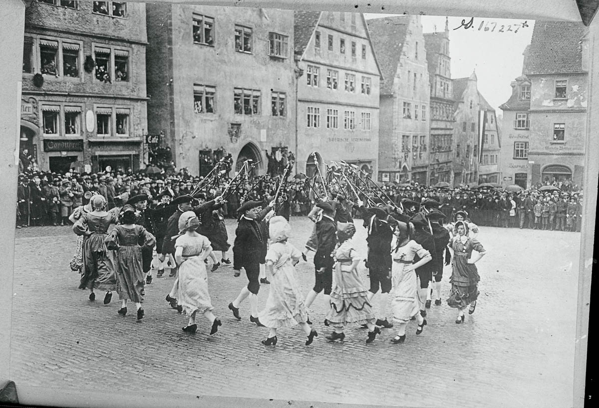 (Original Caption) During the Easter Holiday's in Germany. During the Easter holidays, Germany's most beautiful city of the middle ages "Rothenburg ob der Tauber" celebrated its seven hundred fiftieth birthday with the historical shepards' dance. Lots more or less good music and booze. Many American tourists will remember the beauties of the ancient city near Nuremberg. The famous shepards' dance on the marked square.